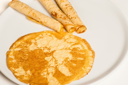An open and three rolled up pancakes