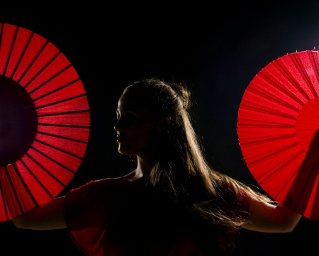 Low key and backlit portrait of a female flamenco dancerの写真素材