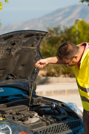 Male making sure his engine is ok for oilの写真素材
