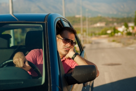 Guy pretty bored while waiting for an open roadの写真素材