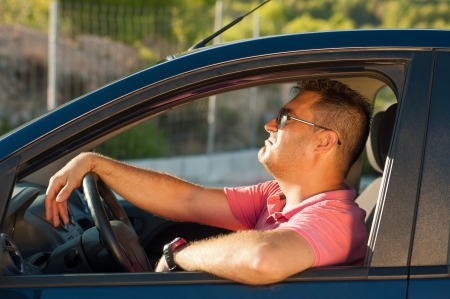 Latin guy inside his car trying to look coolの写真素材