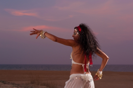 Oriental dance on an evening beach settingの写真素材