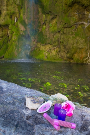 Spa products next to an idyllic waterfalの写真素材