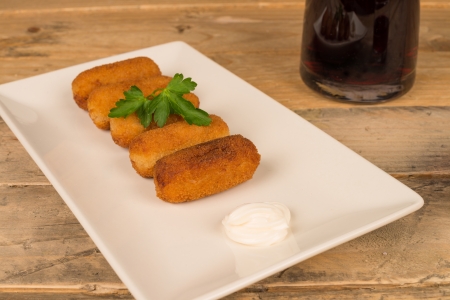 Freshly fried croquettes on a wooden tableの写真素材