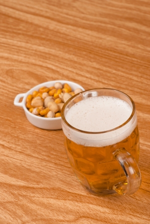 Beer on bar counter with  a crunchy appetizerの写真素材
