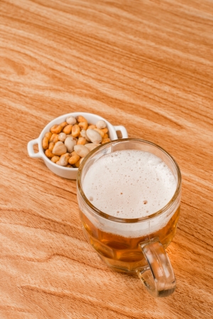 Beer on bar counter with  a crunchy appetizerの写真素材