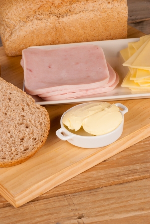 Preparing a whole wheat sandwich with ham and cheeseの写真素材