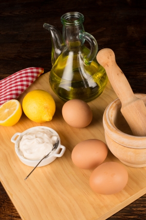 Mayonnaise ingredients on a wooden chopping boardの写真素材