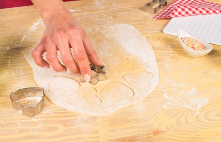 Cutting out pieces of dough to prepare fancy  cookiesの写真素材