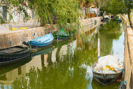 Canal with traditional fishing boats at El Palmar, Valencia, Spainの写真素材