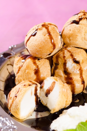 Closeup take of freshly made profiteroles with chocolateの写真素材