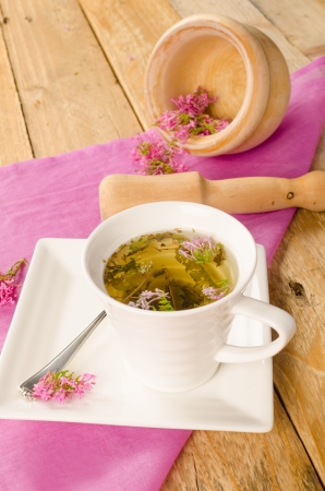 Homemade valerian infusion, with mortar and pestle in the backgroundの写真素材