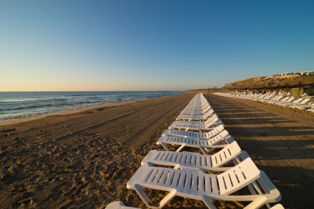 Row of deckchairs on a sunny Mediterranean beachの写真素材