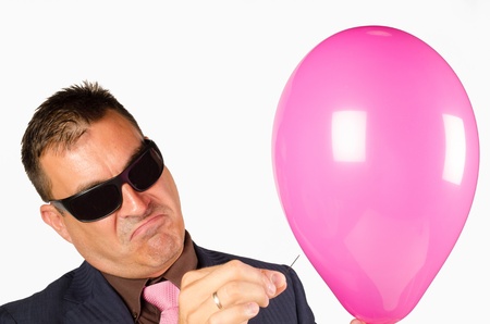 Mafia like guy about to burst a balloonの写真素材