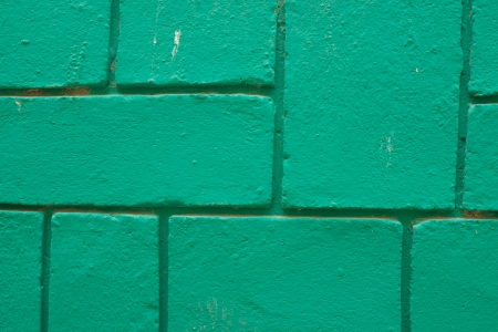 A concrete block wall painted in shiny greenの写真素材