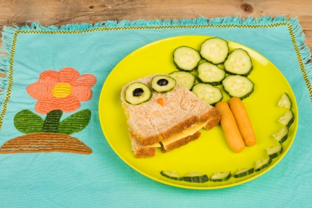 Funny kid sandwiched garnished with vegetablesの写真素材