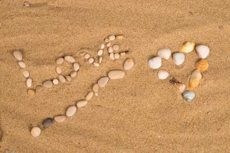A love message on the sand of a sunny beachの写真素材