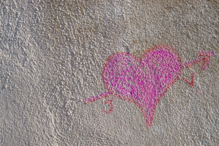 A heart of chalk drawn on an old wallの写真素材