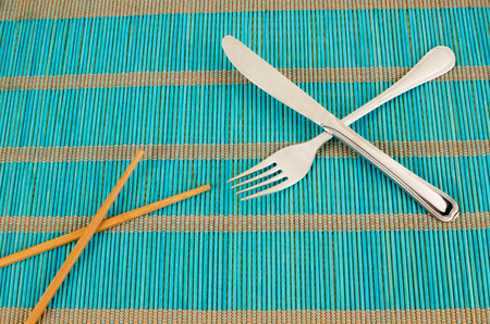 Chopsticks or fork, a still life with a cultural conceptの写真素材