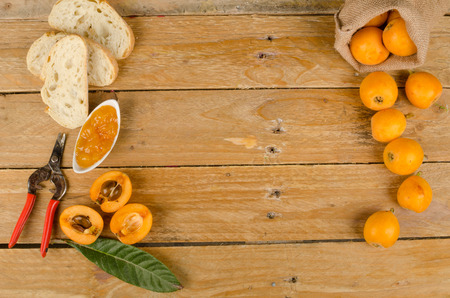 Still life with freshly harvested loquats and homemade marmalade