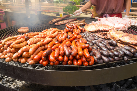 A huge grill loaded with assorted meatの写真素材
