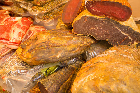Assorted serrano ham on display on a market stall