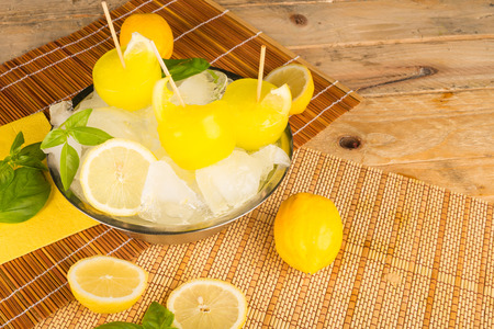 A bowl with  homemade lemon ice popsの写真素材