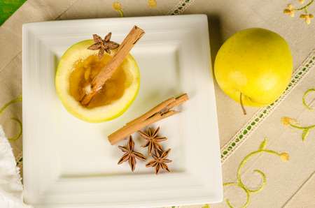 Aromatic cider punch served inside a halved appleの写真素材