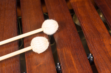 Full frame take of two mallets resting on the keys of  a marimbaの写真素材