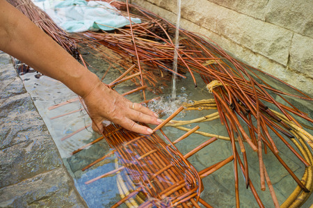 Woaking wicker  in  fresh water to make it flexibleの写真素材