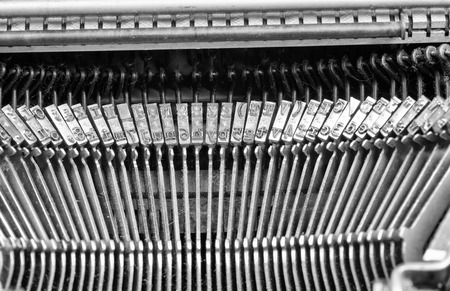 Closeup take of an old typewriter mechanism with its set of keys and letters
