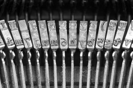 Closeup take of an old typewriter mechanism with its set of keys and lettersの写真素材
