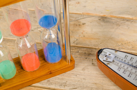 An hourglass and a metronome, a time conceptの写真素材