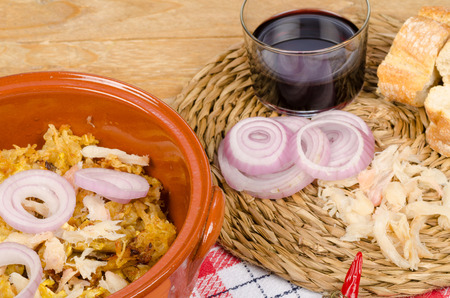 Traditional Portuguese cod caserole werved with red wineの写真素材