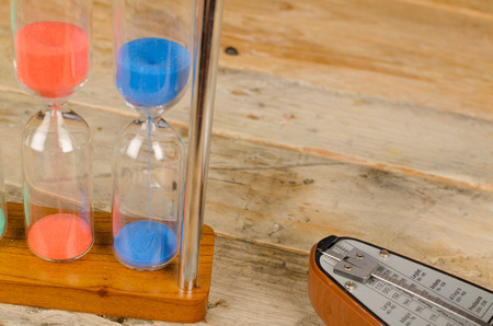 An hourglass and a metronome, a time conceptの写真素材