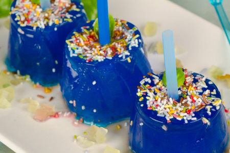 Fruity blue ice pops decorated with sugar sprinklesの写真素材