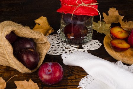 Plum brandy and its ingredients in a autumnal settingの写真素材