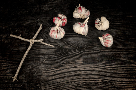 Exorcism still life,a a wooden cross and garlic bulbsの写真素材