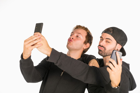 Two guys in their twenties having fun with selfiesの写真素材