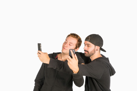 Two guys in their twenties having fun with selfiesの写真素材
