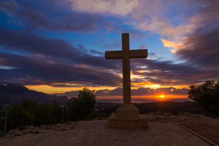 A huge stone cross against a dramatic skyの写真素材