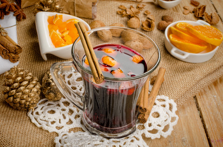 A glass of hot glogg surrounded by ingredientsの写真素材