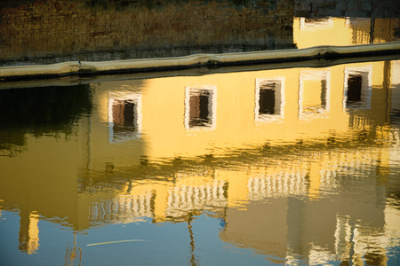 Traditional farmhouse reflected in the calm waters of Albufera lagoon, Valencia, Spainの写真素材