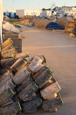 Fish farming equipment on a harbor pierの写真素材