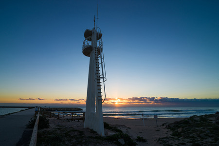 Lifeguard watchtower on a beach at sunrise