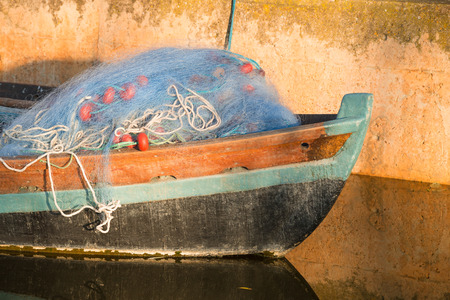Old boat with fishing nets on its prow