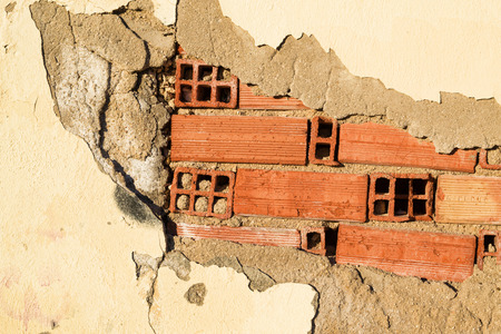 Full frame take of a wall with its plaster coming off