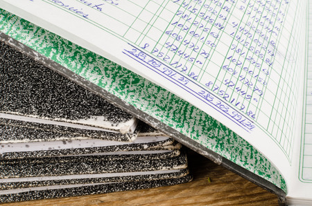 Old  ledger books,  the top one open and dislpaying handwritingの写真素材