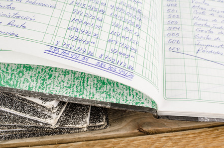 Old  ledger books,  the top one open and dislpaying handwritingの写真素材