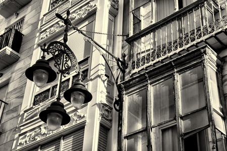 Old urban facade with a classic street lightの写真素材